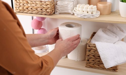 Bath accessories. Woman organizing personal care products indoors, closeup