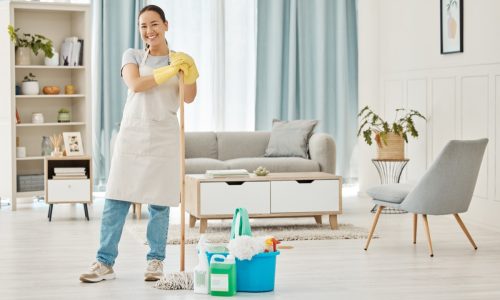 Happy woman cleaning home floor, house work and smile in home service mopping living room, job with.